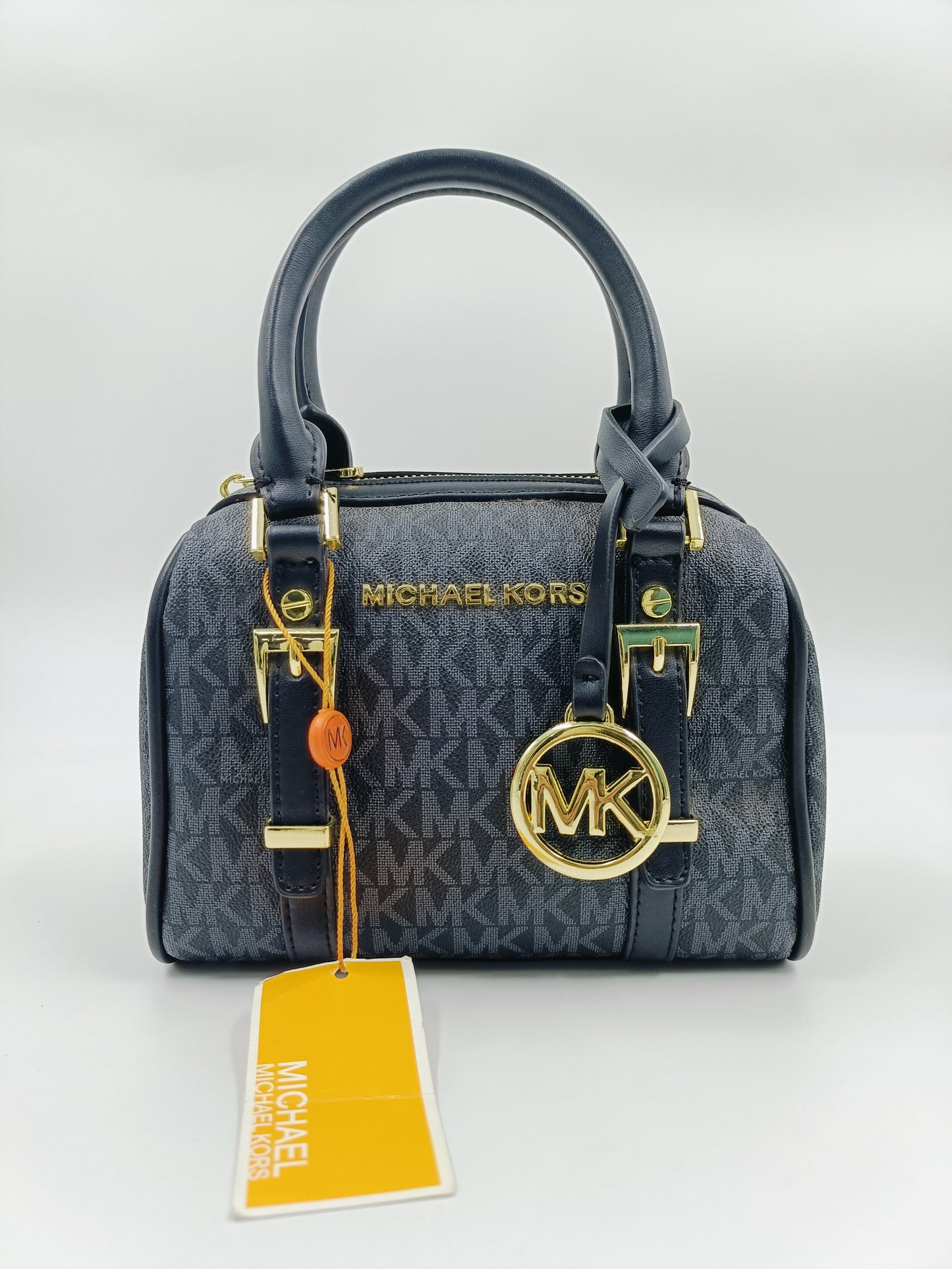 Front view of Michael Kors Mini Barrel Bag in navy monogram with gold MK logo charm and top handles.